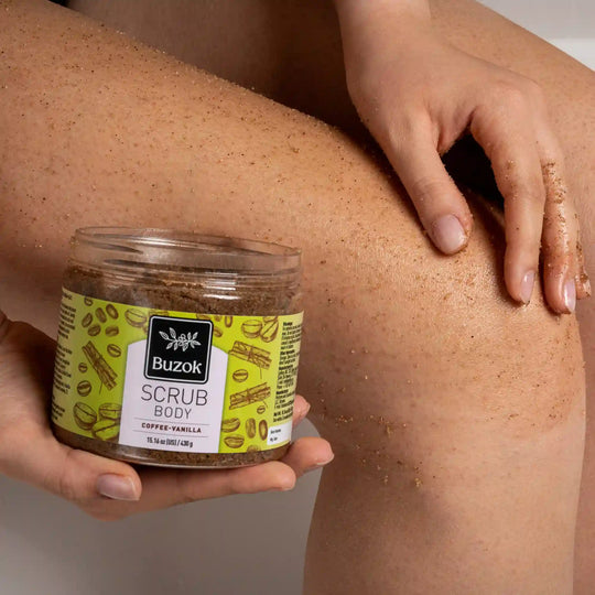 Person using a Buzok coffee vanilla body scrub on their leg
