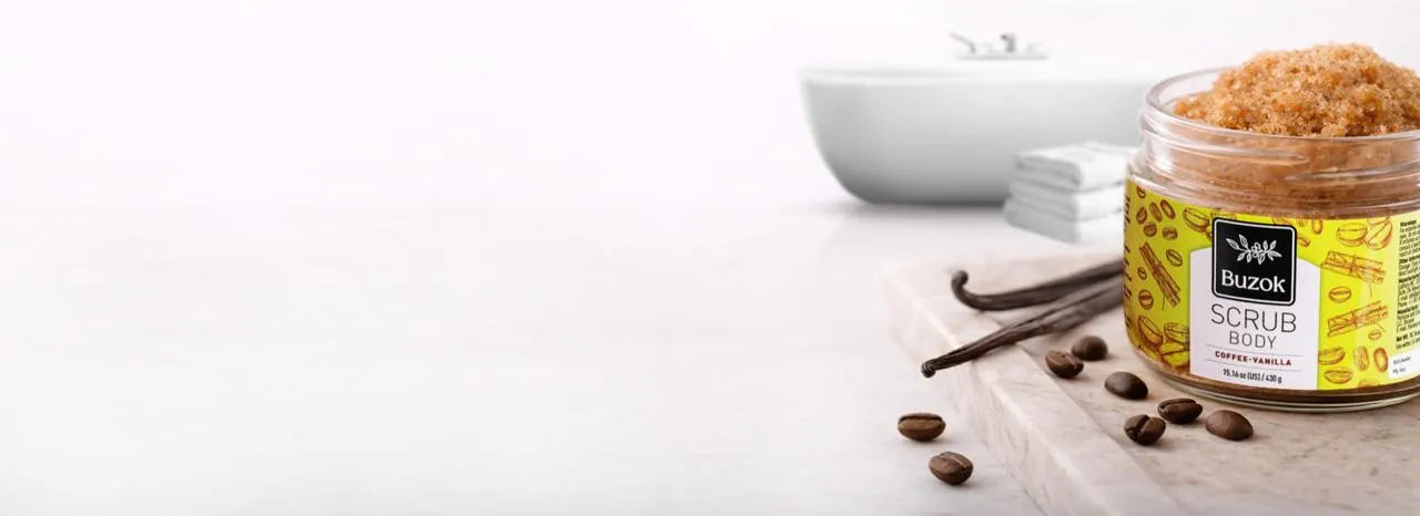 Jar of scrub with coffee beans and vanilla sticks on a white background